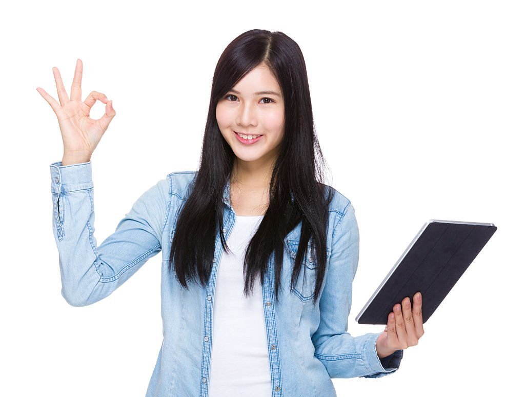 Woman holding a tablet and making ok sign